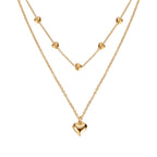 Gold-tone double-layer necklace with small heart charms and a larger heart pendant