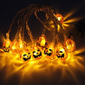 Orange pumpkin-face Halloween string lights shown illuminated