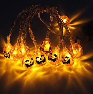 Orange pumpkin-face Halloween string lights shown illuminated