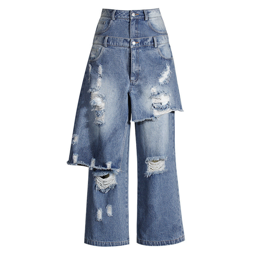 Front view of blue distressed jeans with asymmetric layered panels and a double waistband