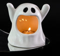 White ghost-shaped ceramic candle holder shown with a lit display tealight