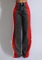 Black trousers with red side panels and white stripe details, shown from waist to hem.