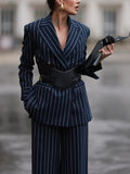 Navy pinstriped blazer shown from the front with notched lapels and a broad black waist belt.