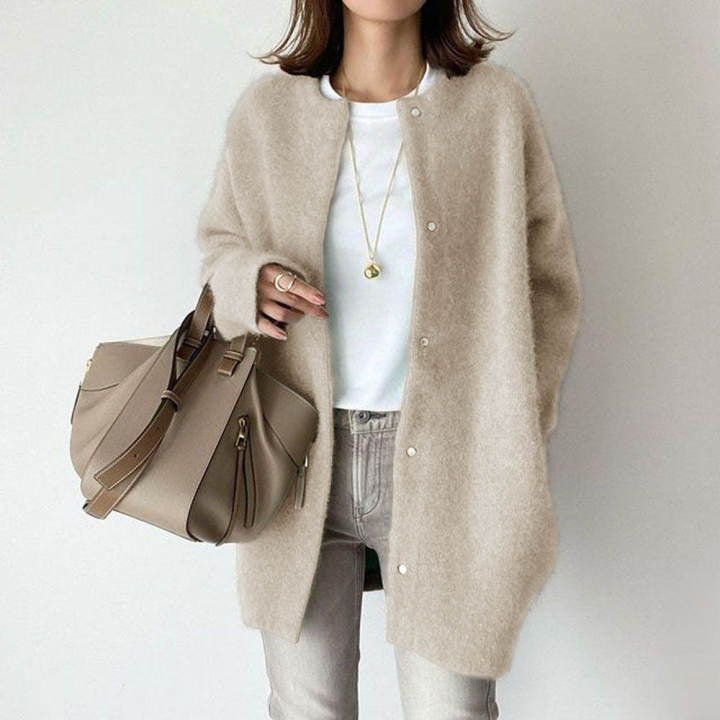 Beige-apricot round-neck button-front cardigan, worn over a white top