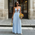 Light blue and white striped halter maxi dress with a V-neck, brown piping and cut-out waist.