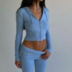 Model wearing a light blue ribbed zip hoodie and matching trousers