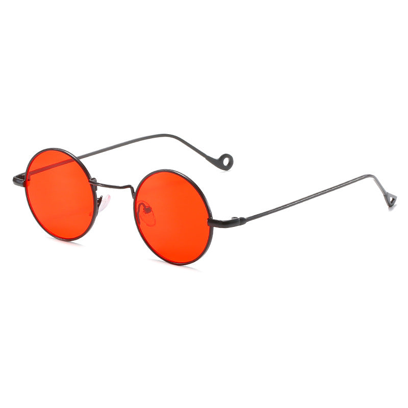 Round orange-red lens sunglasses with dark metal frames on a white background
