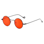 Round orange-red lens sunglasses with dark metal frames on a white background
