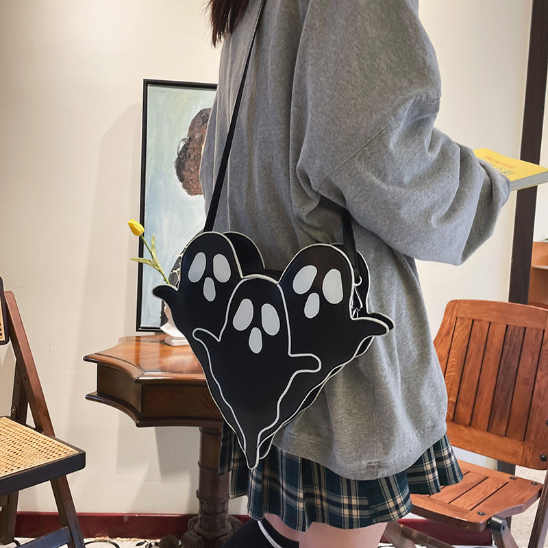 Black Ghost Crossbody Bag worn at the hip with its shoulder strap.