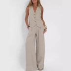 Model wearing a beige sleeveless button-front vest and wide-leg trousers