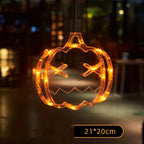 Orange pumpkin-shaped LED hanging light, illuminated against a dark background, with a 21 by 20 cm size label.