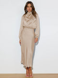 Beige long-sleeve dress with a draped high neckline and gathered waist.