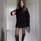 Black knit pullover and mini skirt set shown worn indoors