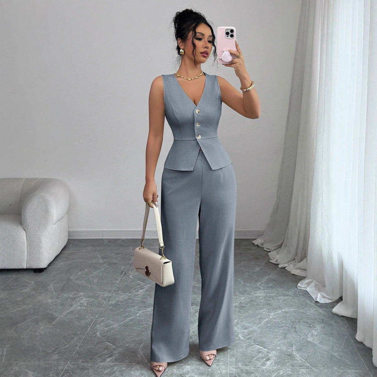 Grey V-neck three-button vest with matching wide-leg trousers.
