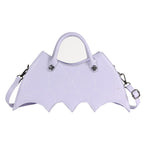 Lavender bat-wing-shaped crossbody bag with spider-web stitching, handles and strap on white.