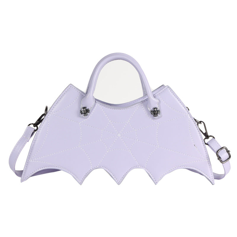 Lavender bat-wing-shaped crossbody bag with spider-web stitching, handles and strap on white.