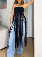 Model wearing a black bandeau top with long fringe over blue jeans