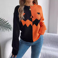 Orange-and-black jack-o'-lantern knit sweater worn on a model.