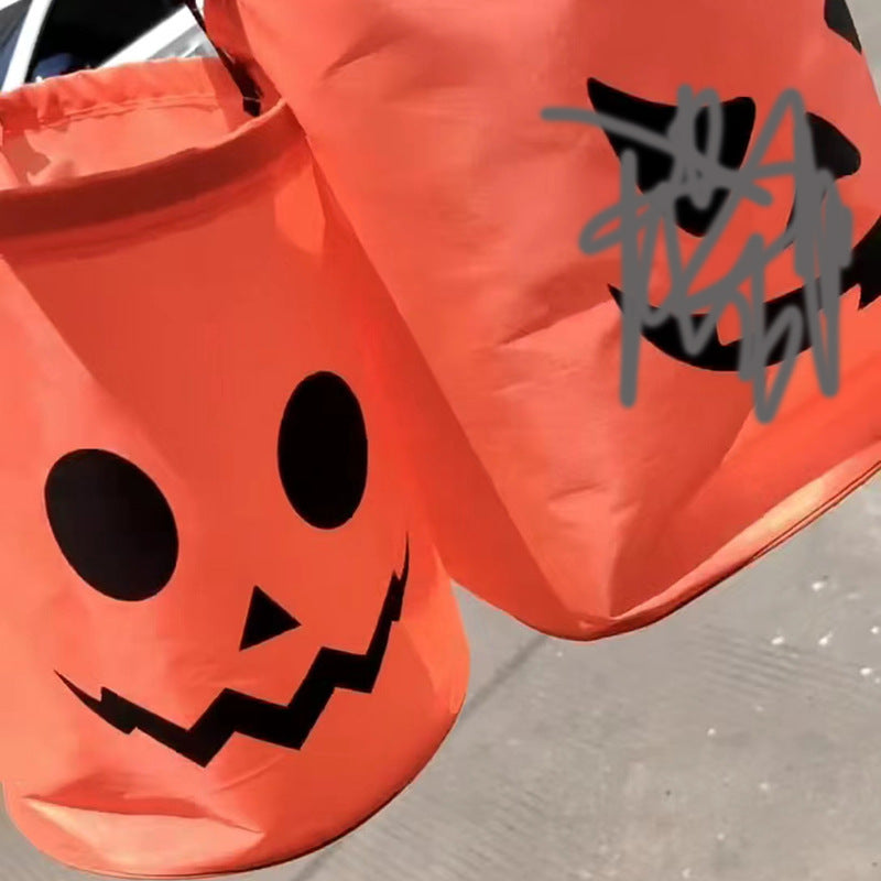 Close views of orange Halloween candy bags with black printed faces.