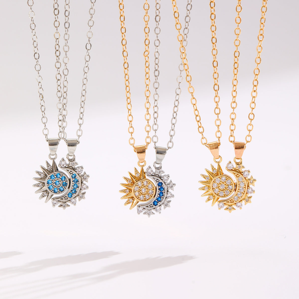 Sun and crescent moon necklace pairs in three colour combinations, shown as separate options on a pale background.