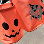 Close views of orange Halloween candy bags with black printed faces.