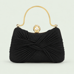 Pleated Shimmer Evening Bag in Black on a pale sage background